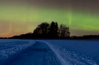 Skating track on frozen lake under the aurora borealis