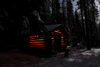 Woodshed in forest under a full moon