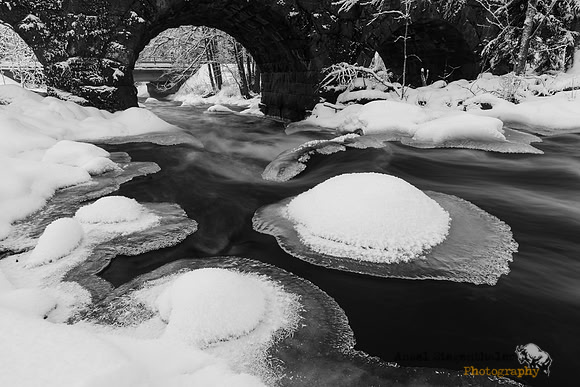 Ice caps under stone bridge