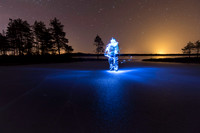 Light painted figure on frozen lake