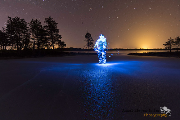 Light painted figure on frozen lake