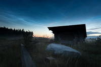 Noctilucent clouds in summer sky above shelter