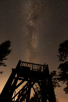 Starry night sky with lookout tower